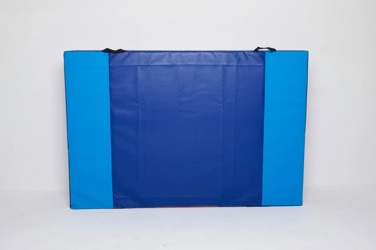 Blue rectangular folding mat with a darker center panel, lighter blue side panels, and black carry handles at the top.