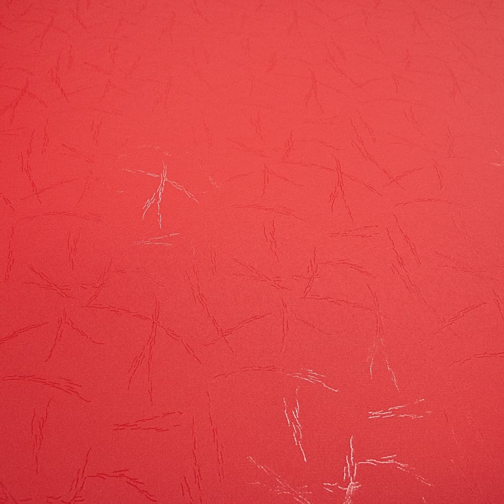 Red tatami-finish high-density foam mat surface with subtle textured lines and a few light scuff marks.